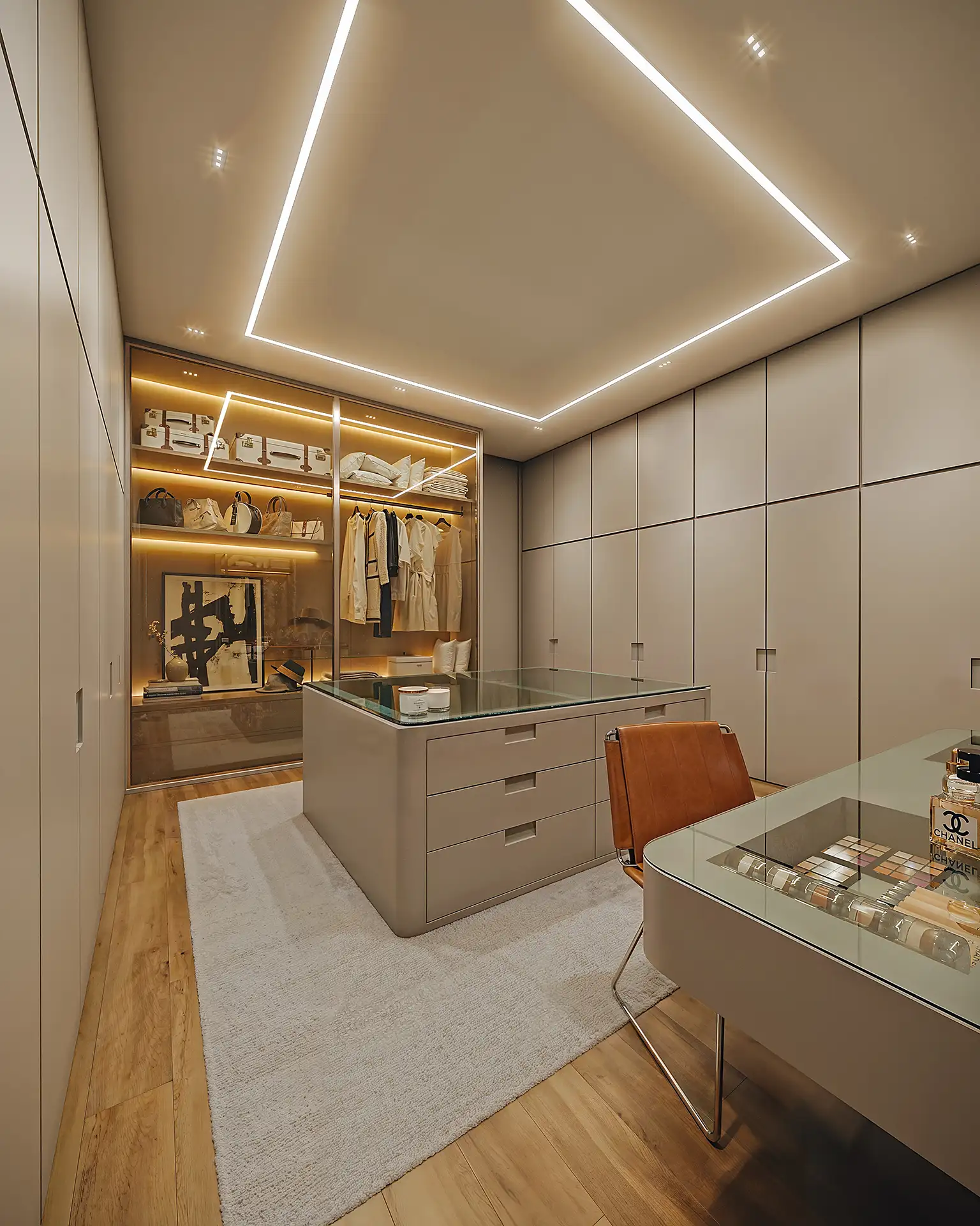 LUX 600 — closet do duplex com iluminação embutida, ilha central e penteadeira — curadoria iApartamentos — Vila Nova Conceição